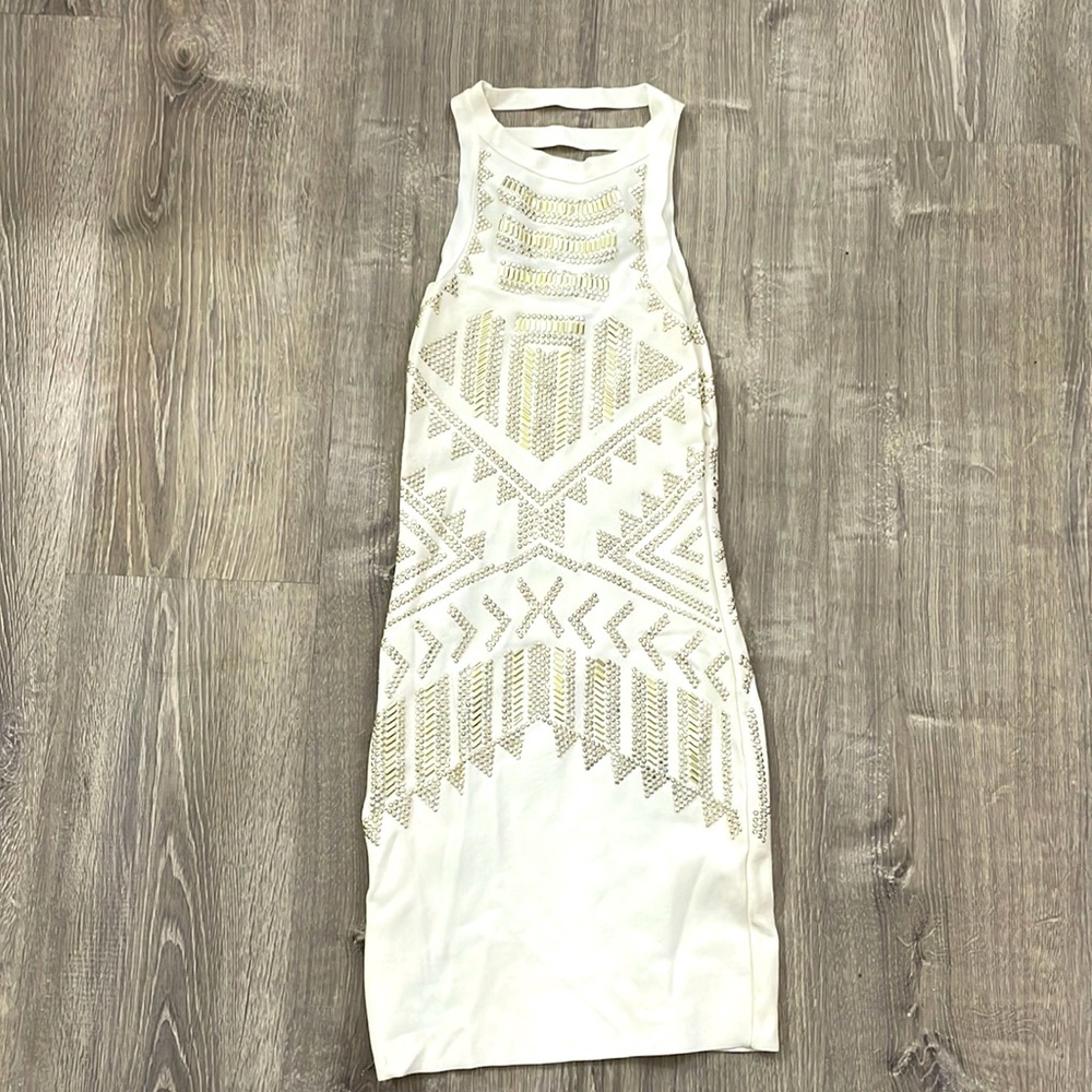 White dress with silver and gold beading/studs.